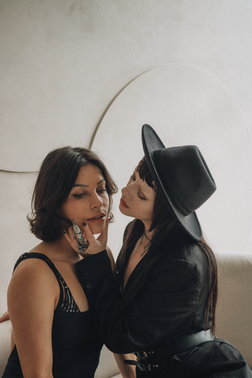 Free Elegant portrait of two women in fashionable attire indoors, conveying timeless style. Stock Photo