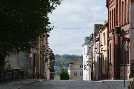 Cobblestone street flanked by historic European buildings, showcasing quaint charm and vintage architecture.