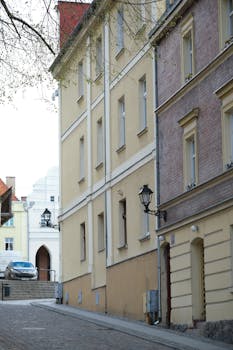 Scenic view of an uphill cobblestone street lined with historical European buildings, perfect for travel and history themes.