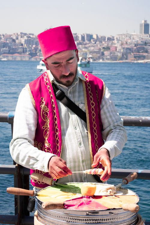 Free Traditional Turkish ice cream vendor making ice cream on the waterfront in Istanbul, Turkey. Stock Photo