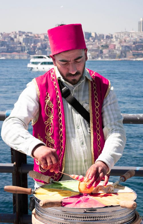 Free Street vendor in Istanbul preparing a colorful dessert by the Bosphorus. Stock Photo