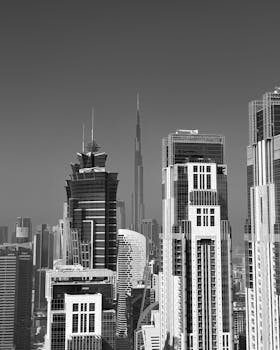 A monochrome view of Dubai's modern architectural skyline featuring the iconic Burj Khalifa.