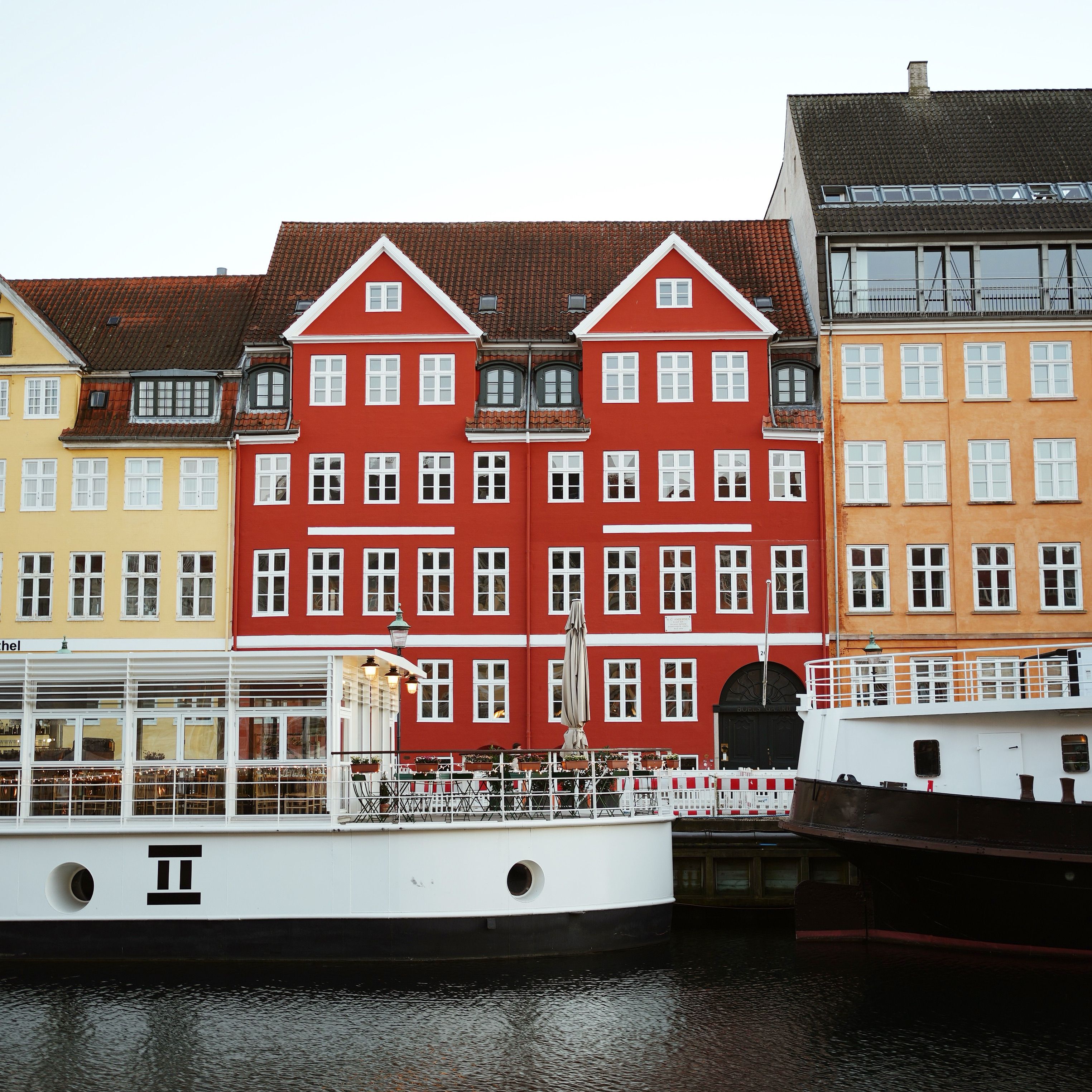 Charming view of colorful historic buildings by the Nyhavn waterfront in Copenhagen.