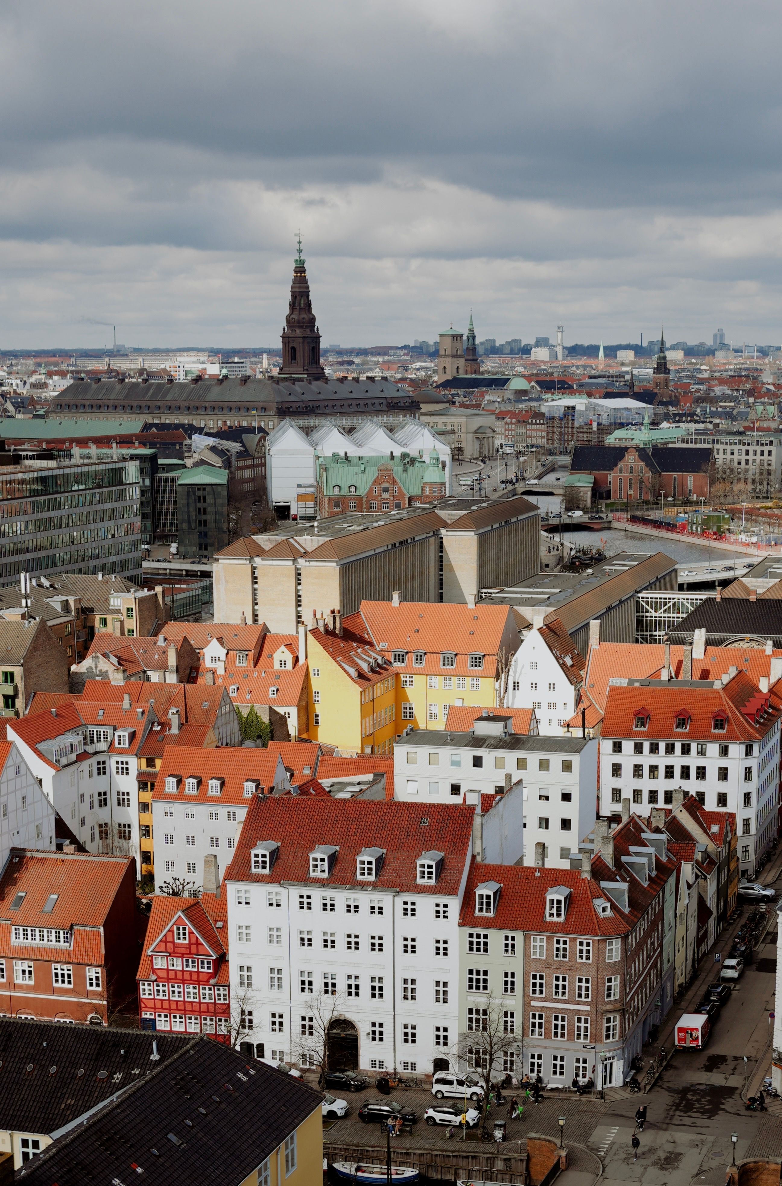 Explore the captivating aerial view of Copenhagen's colorful rooftops, showcasing historic architecture and vibrant city life.