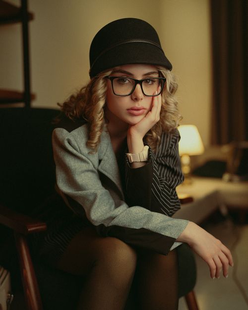 Free Elegant woman in fashionable attire posing indoors during nighttime. Stock Photo
