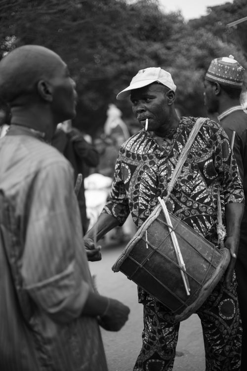 Free Black and white photo of a drummer performing at an African street festival. Stock Photo