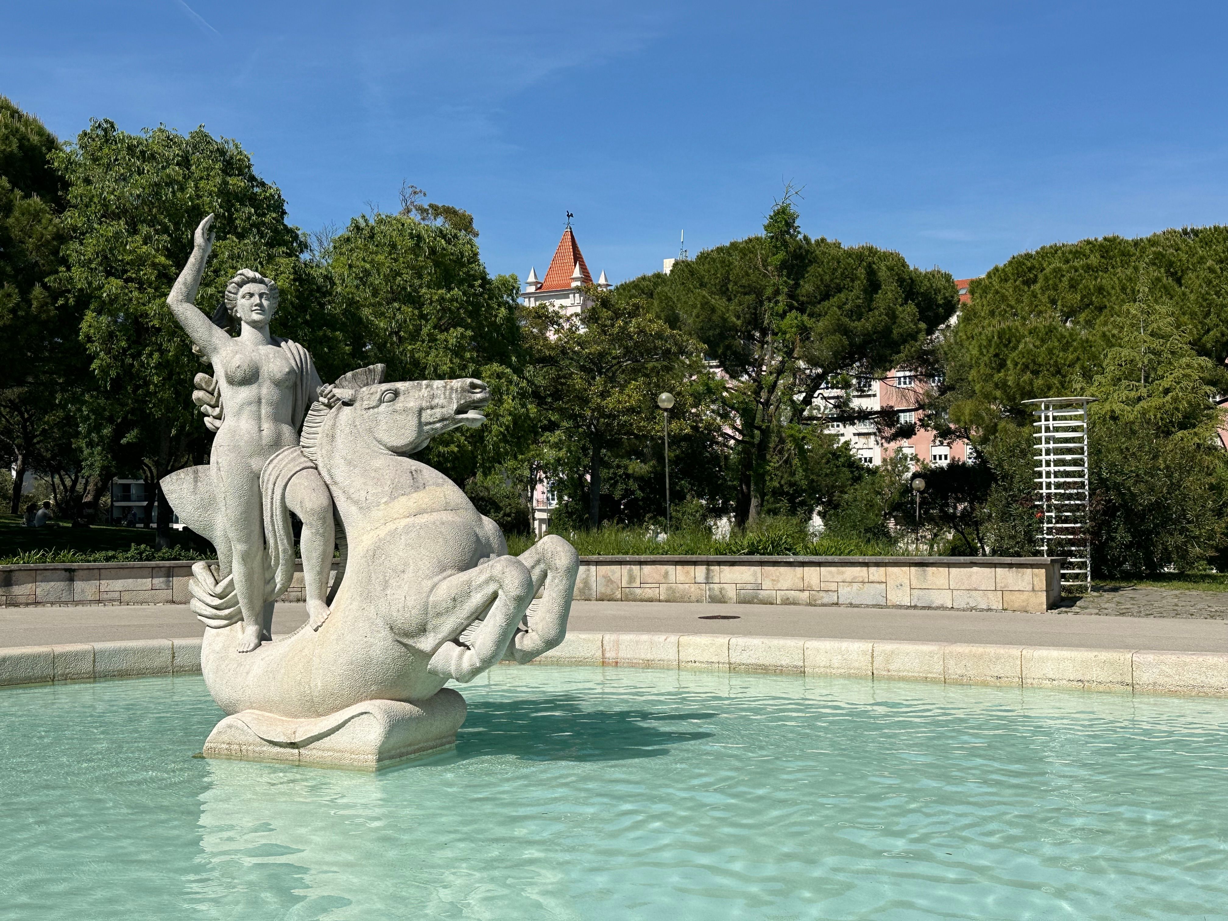 A striking statue depicting a rider on horseback in a fountain at Eduardo VII Park in Lisbon.