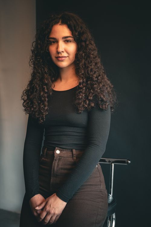 Portrait of a Young Woman with Curly Hair in Berlin · Free Stock Photo