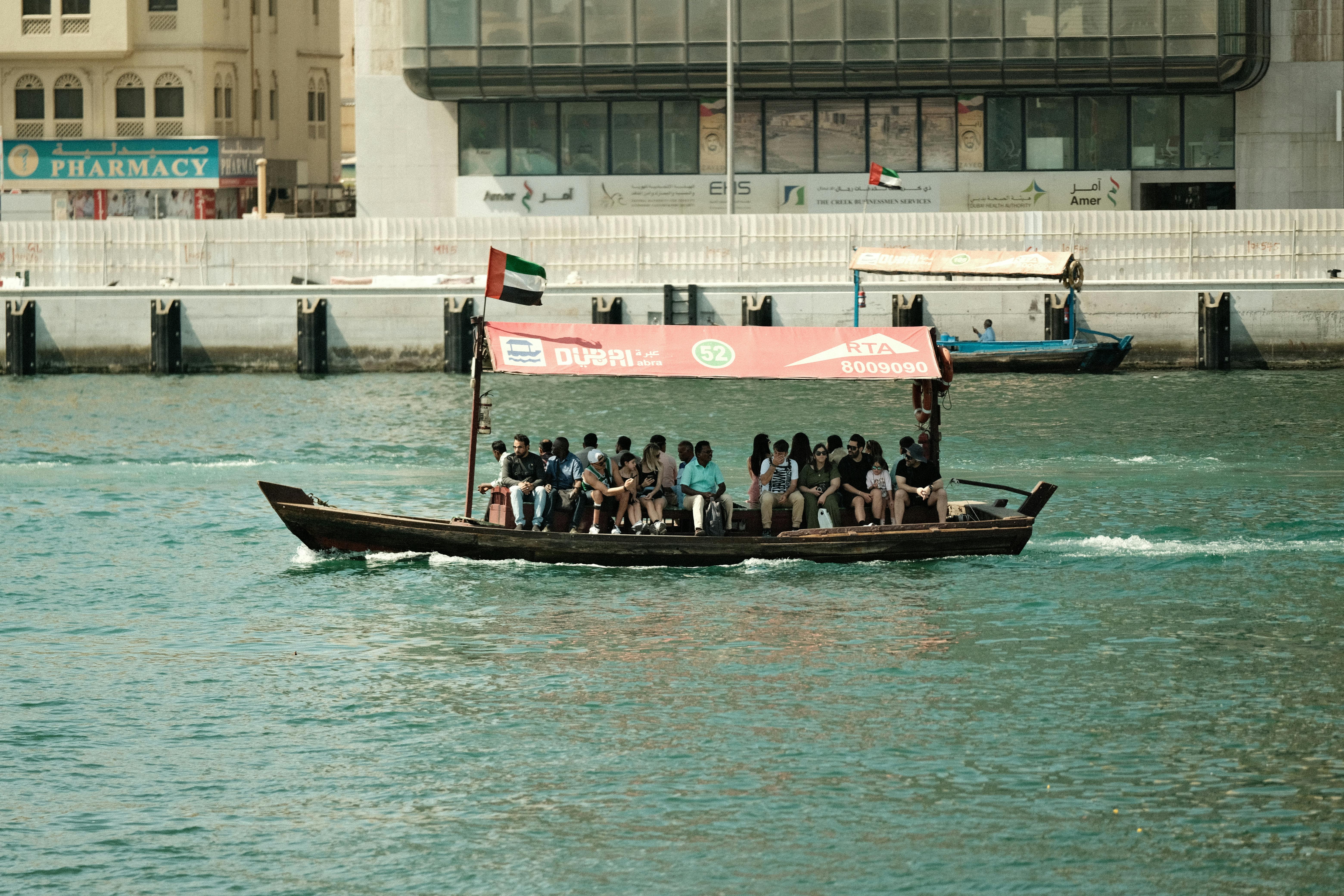 Abra boat ferrying passengers on Dubai Creek, showcasing local culture and transport.