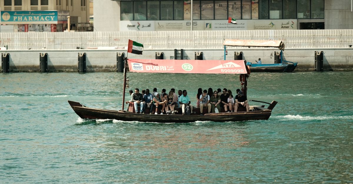 Abra boat ferrying passengers on Dubai Creek, showcasing local culture and transport.