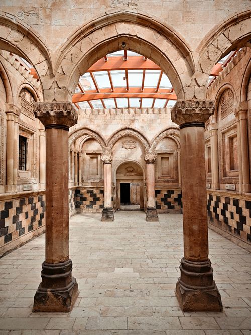 Free Explore the intricate interior arches of historic Armenian architecture, featuring a blend of stone and wood elements. Stock Photo