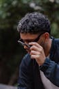 Stylish Man Adjusting Sunglasses Outdoors