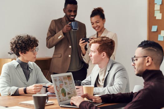 A group of diverse professionals brainstorming ideas during an indoor meeting.
