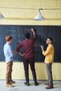 Photo Of Man Writing On Blackboard
