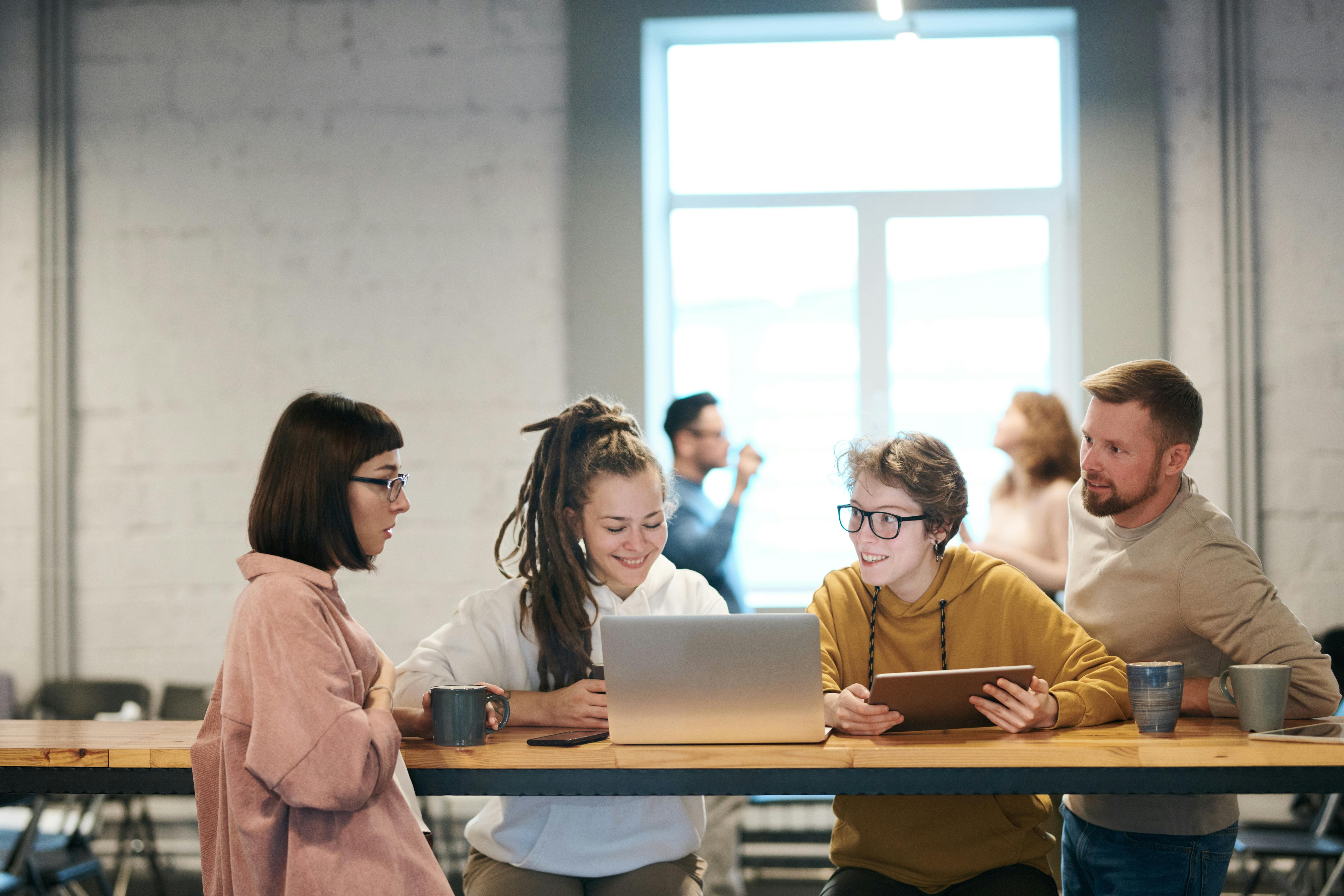 Photo Of People Leaning On Wooden Table