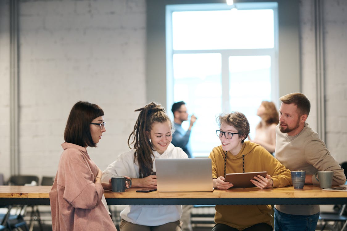 Free Photo Of People Leaning On Wooden Table Stock Photo