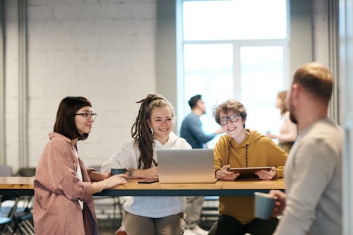 Photo Of People Sitting Near Table