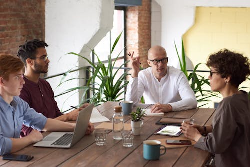 Free Man Wearing White Long-sleeved Shirt Holding Black Pen Stock Photo