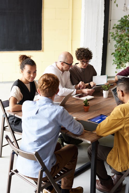 Photo Of People Gathering Around Table