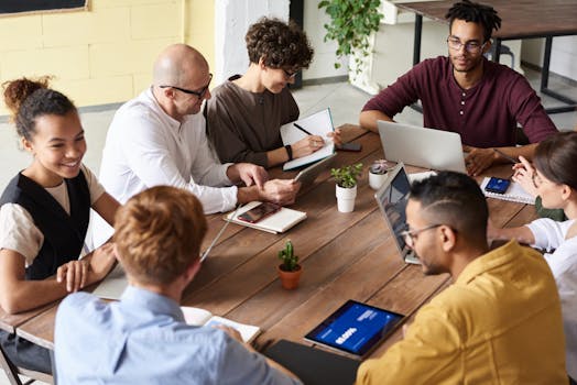 A group of professionals having a meeting in a modern office environment, fostering teamwork and brainstorming.