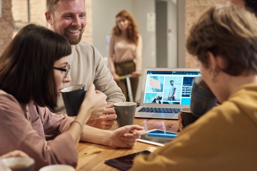 Colleagues enjoy a coffee while collaborating on a project in a modern office setting.