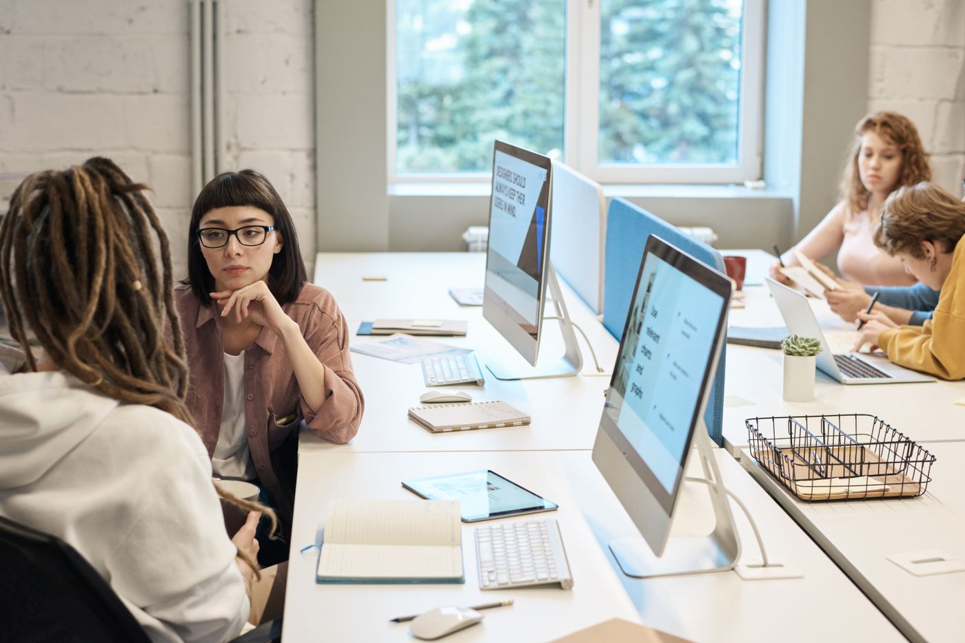 Colleagues working together in a bright modern office — photo by fauxels on Pexels