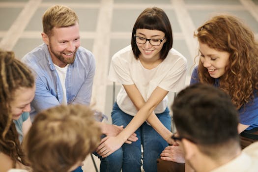 A diverse group of adults laughing and bonding together in an indoor setting.