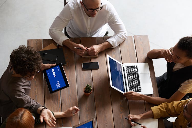 Top View Photo Of People Having A Meeting