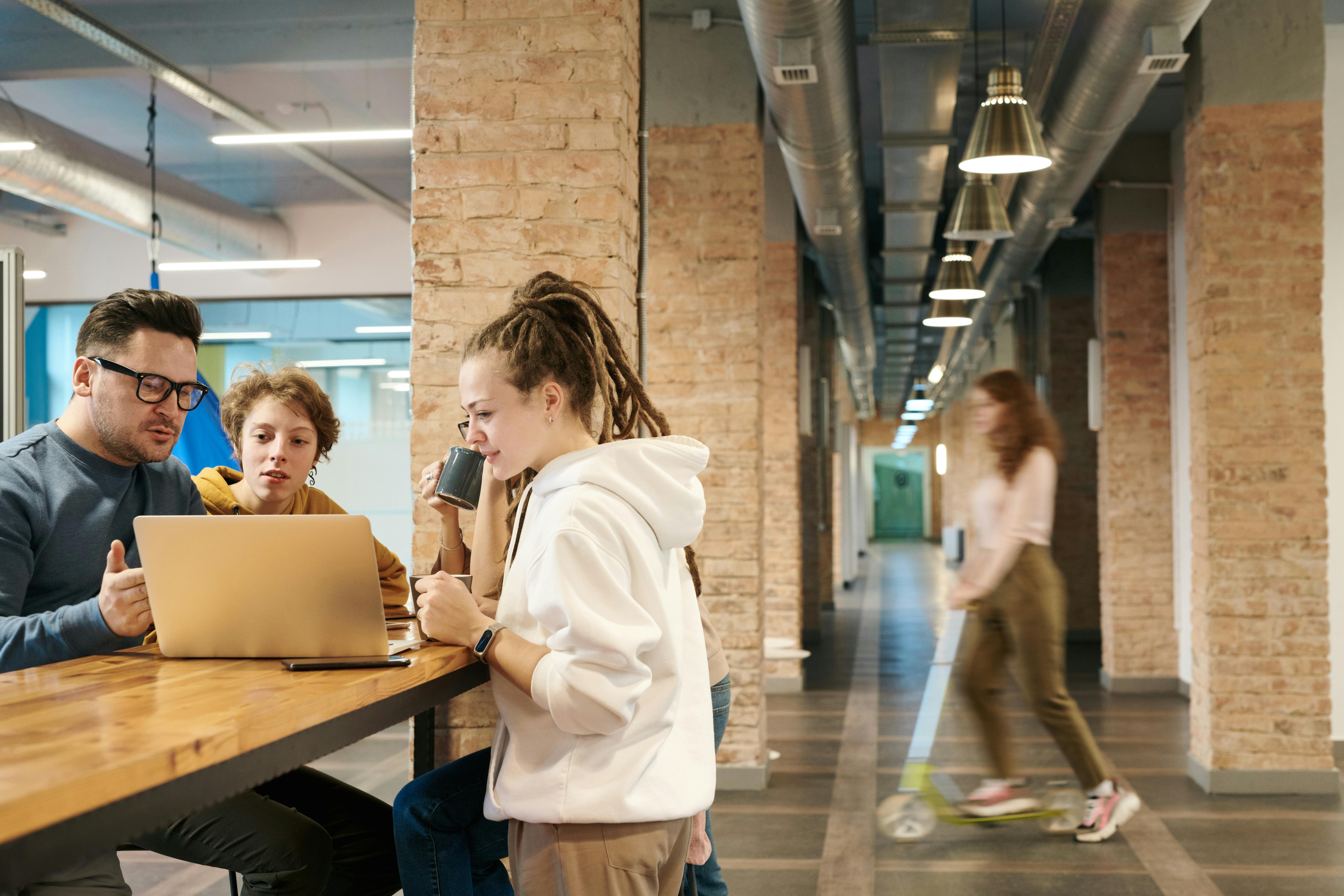 Photo Of People Looking On Laptop