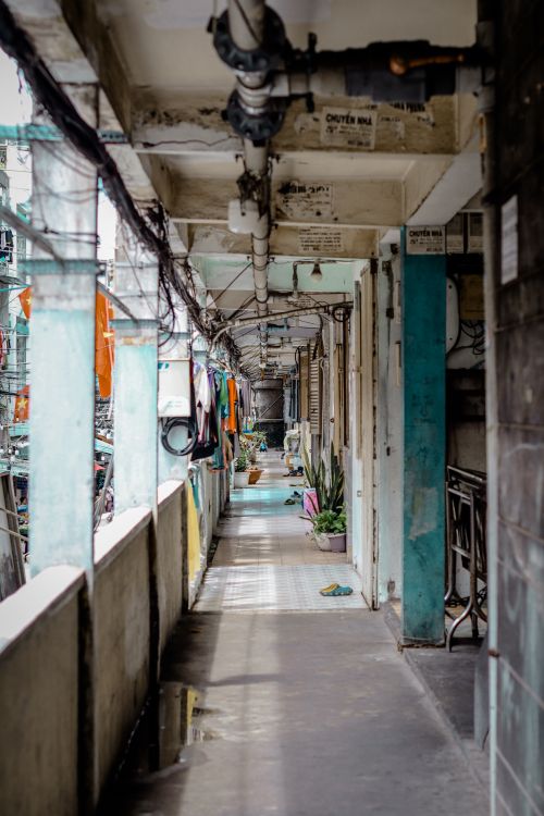 Free Long corridor in an urban apartment showing laundry and plants, in natural daylight. Stock Photo