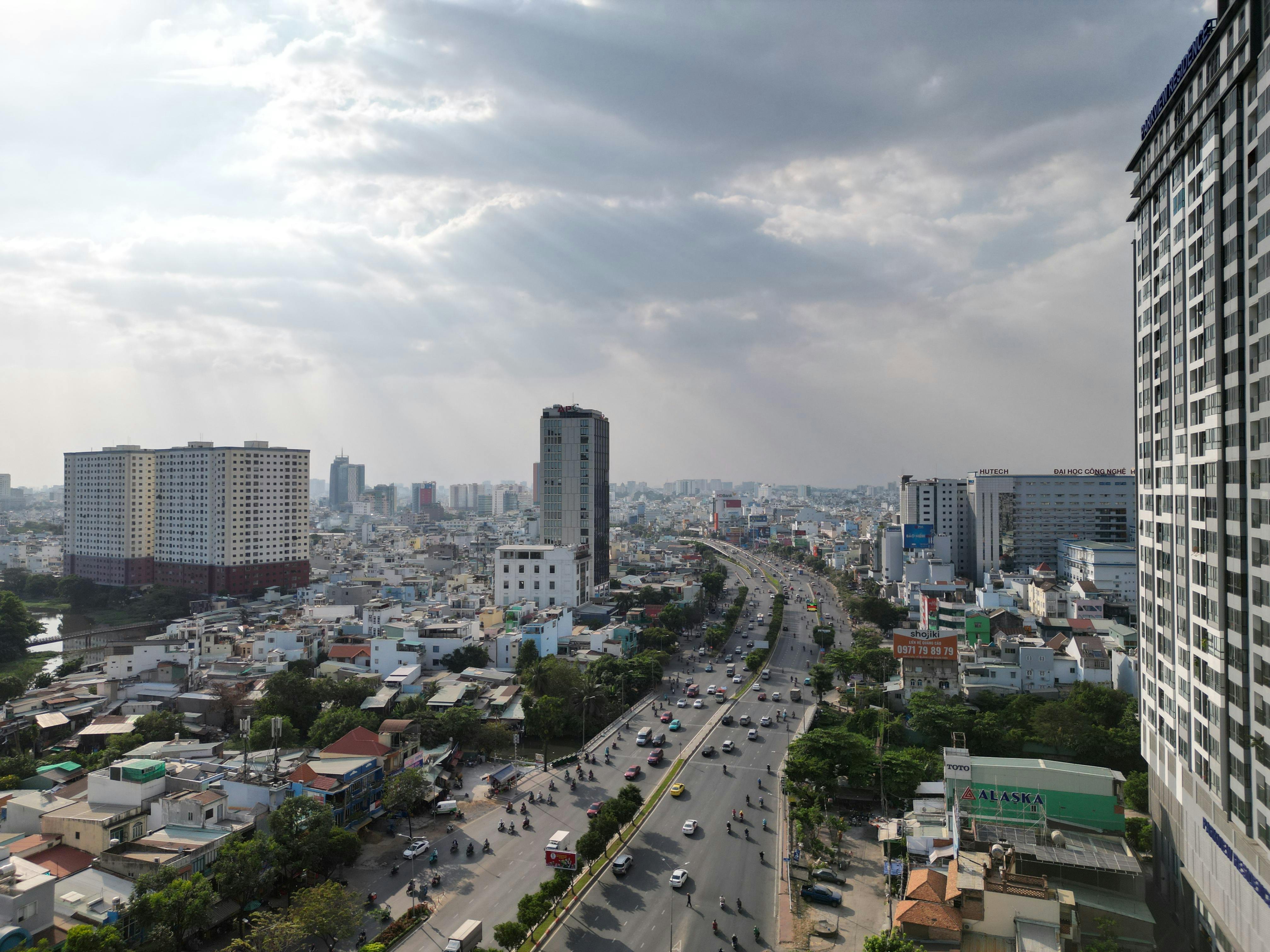 Aerial view of a busy street in Ho Chi Minh City, showcasing modern architecture and vibrant urban life.