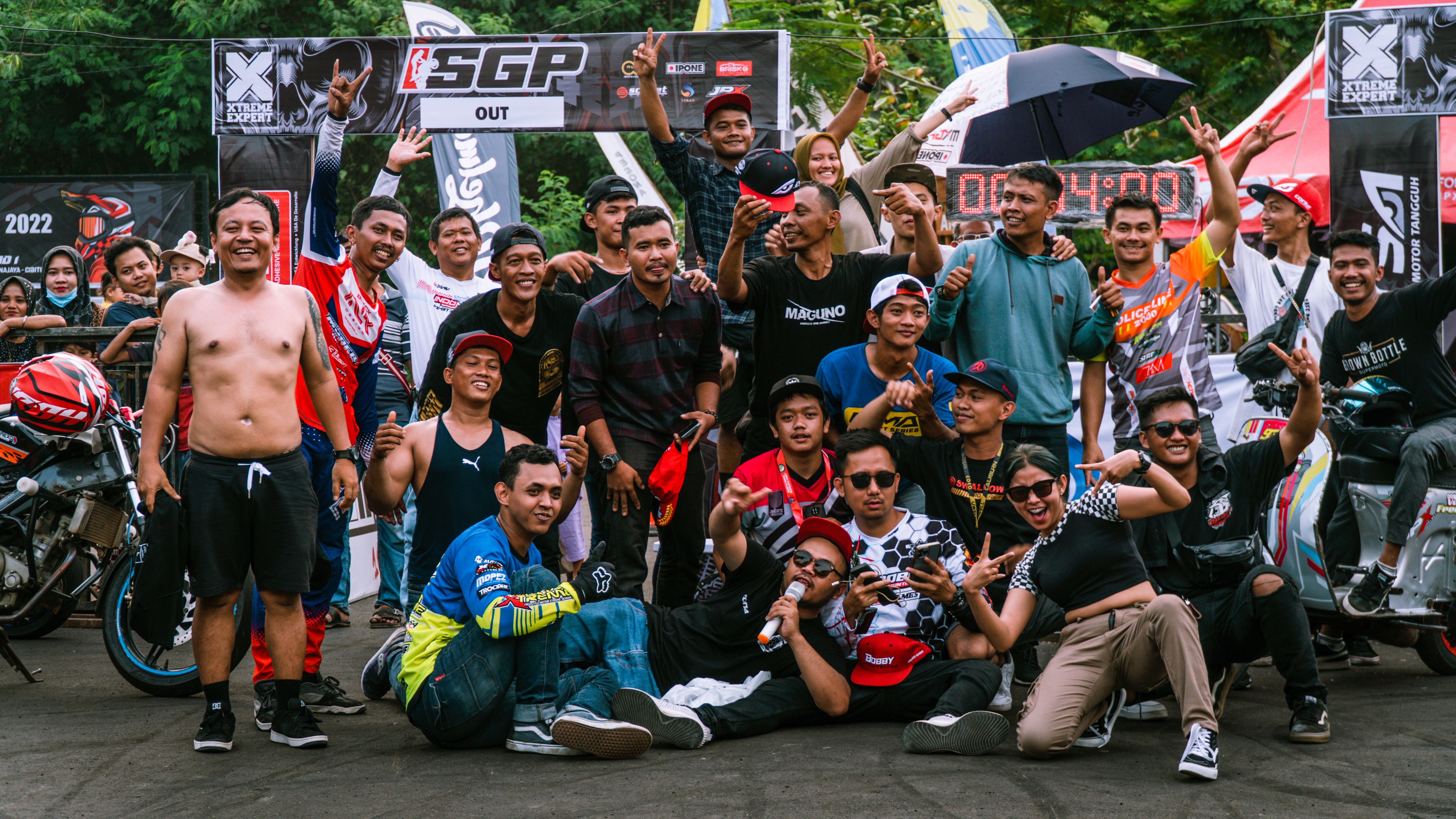Group of riders pose for a photo at a motorcycle stunt competition in Jakarta, Indonesia.