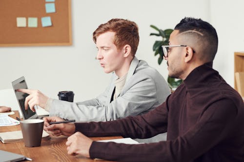 Man Pointing On Laptop Screen