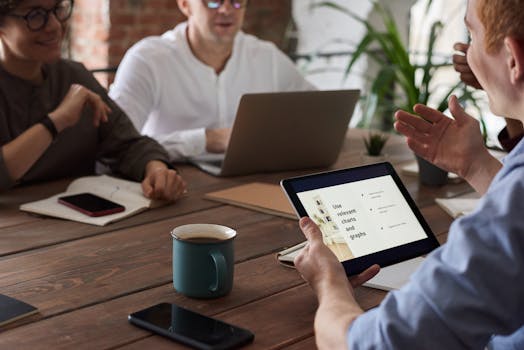 Professionals engage in a collaborative meeting with digital tools, fostering teamwork and innovation.