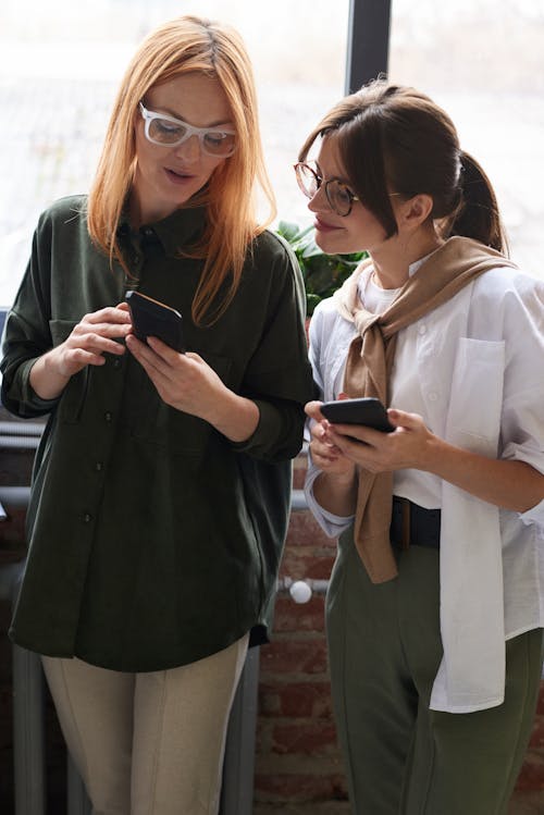 Free Photo Of Women Looking On Their Cellphones Stock Photo