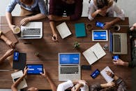 Top View Photo Of People Near Wooden Table