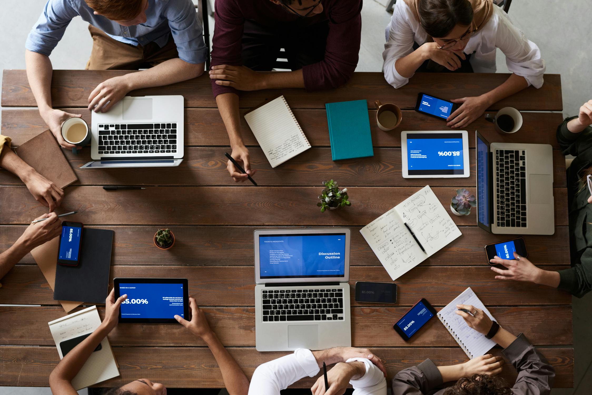 Workers around tables with devices