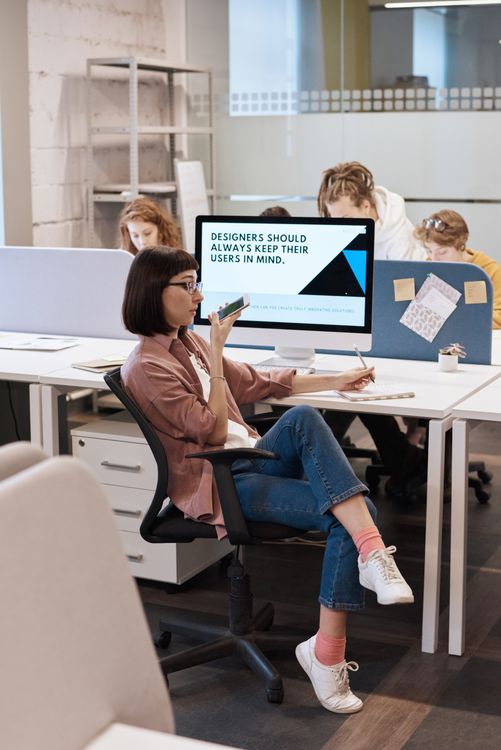 Photo Of Woman Sitting Near Computer · Free Stock Photo
