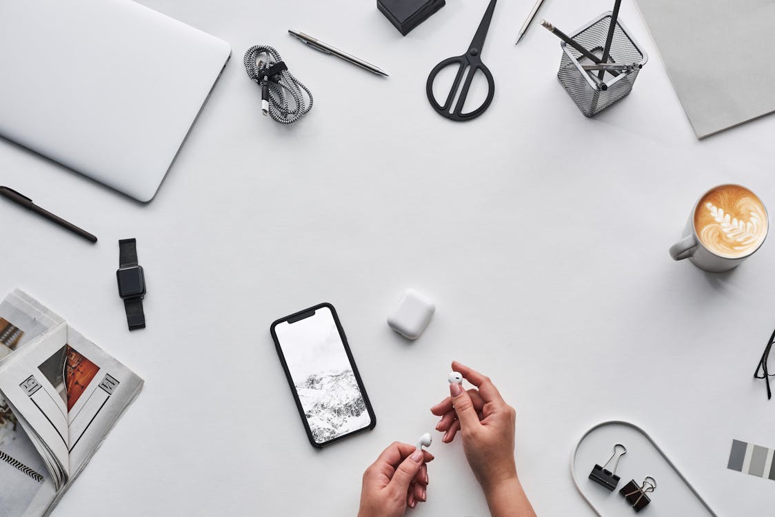 Top View Photo of Person Holding Earphones