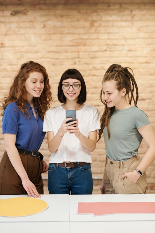 Photo Of Women Looking On Smartphone
