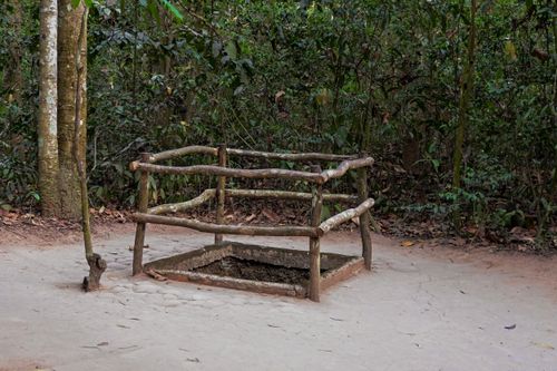 Free Entrance to the historic Cu Chi Tunnels in Vietnam, surrounded by lush forest. Stock Photo