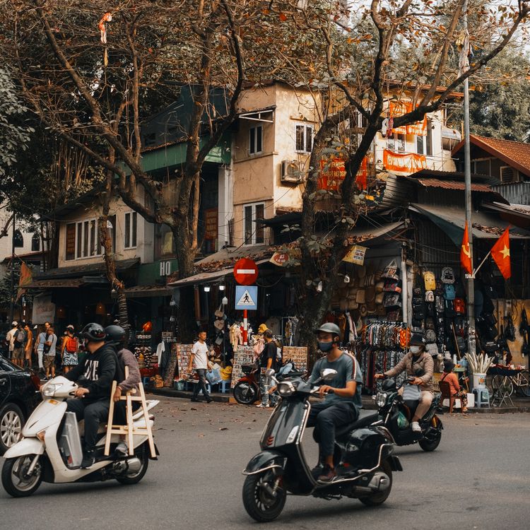 Busy street scene with motorbikes in Hanoi Old Quarter
