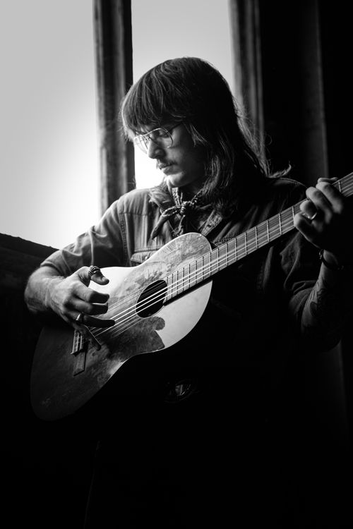 Free Artistic black and white portrait of a guitarist playing indoors, NSW Australia. Stock Photo