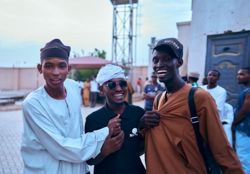 Free Group of young men enjoying a sunny day outdoors, expressing joy and friendship. Stock Photo
