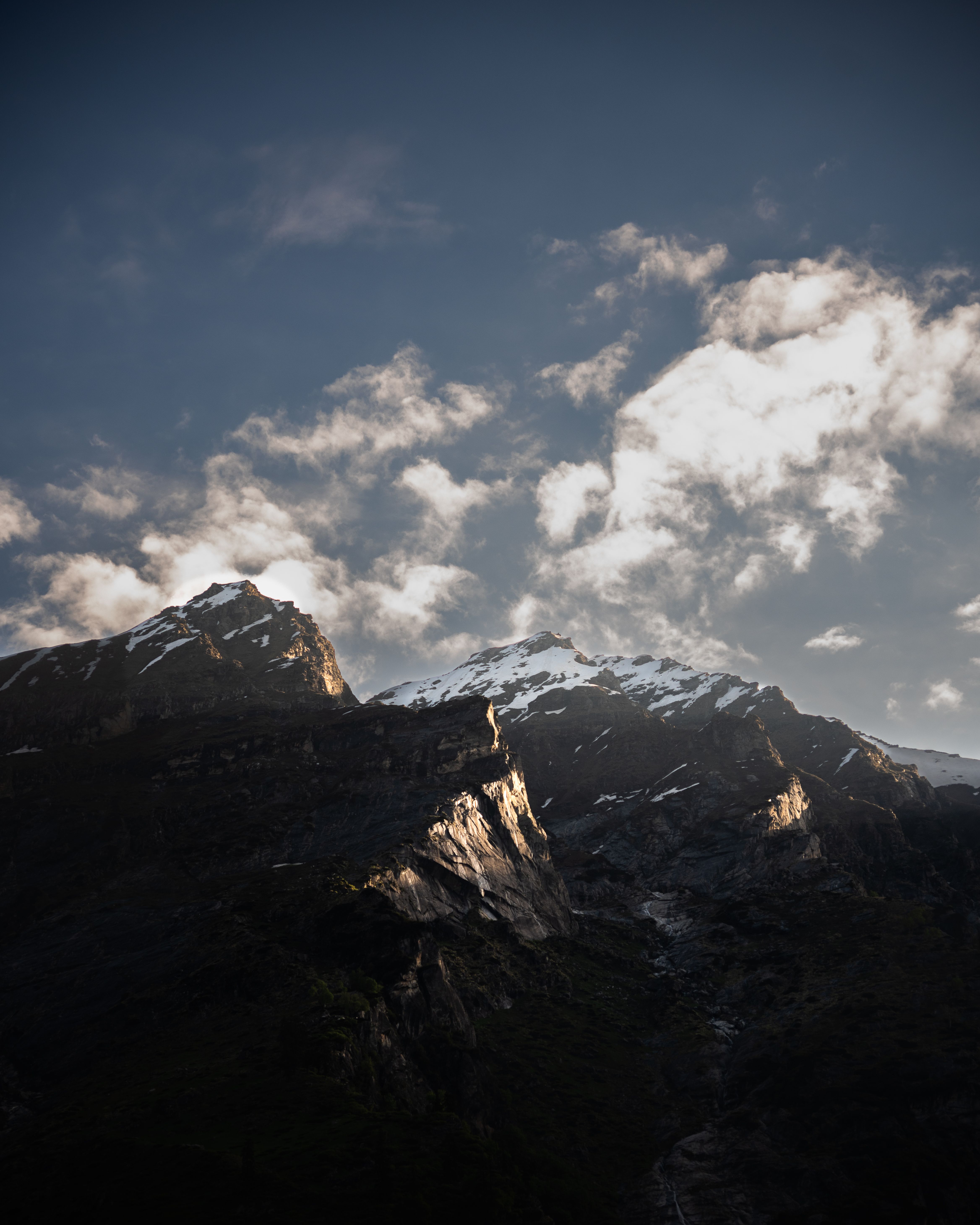 Majestic Himalayan mountains under a dramatic twilight sky, showcasing snow-capped peaks and vibrant clouds.