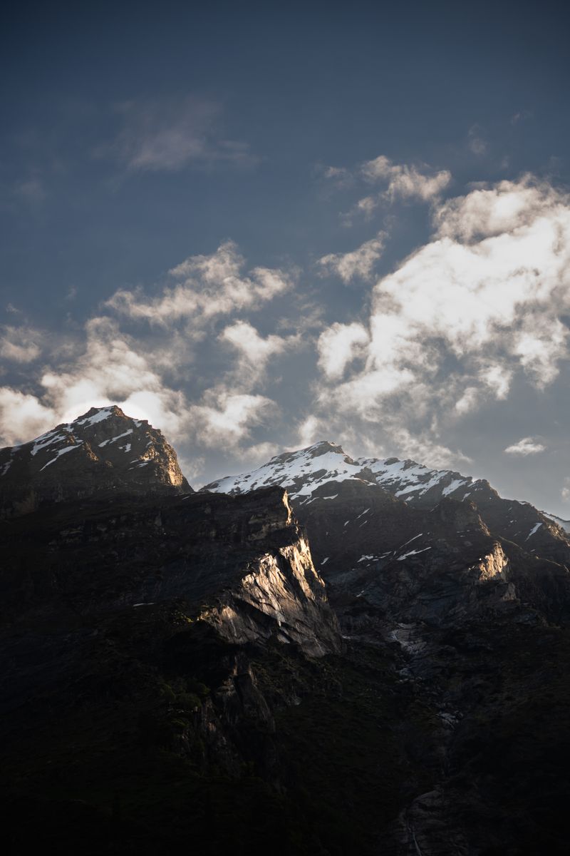 Majestic Himalayan mountains under a dramatic twilight sky, showcasing snow-capped peaks and vibrant clouds.