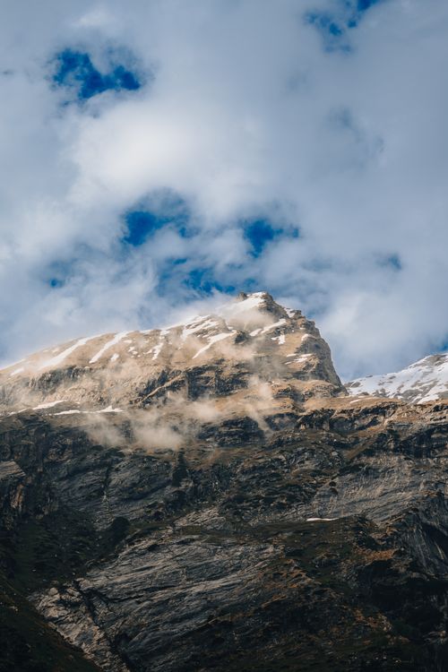 Free Capture the breathtaking beauty of a snow-capped mountain peak under a dramatic sky in Himachal Pradesh, India. Stock Photo