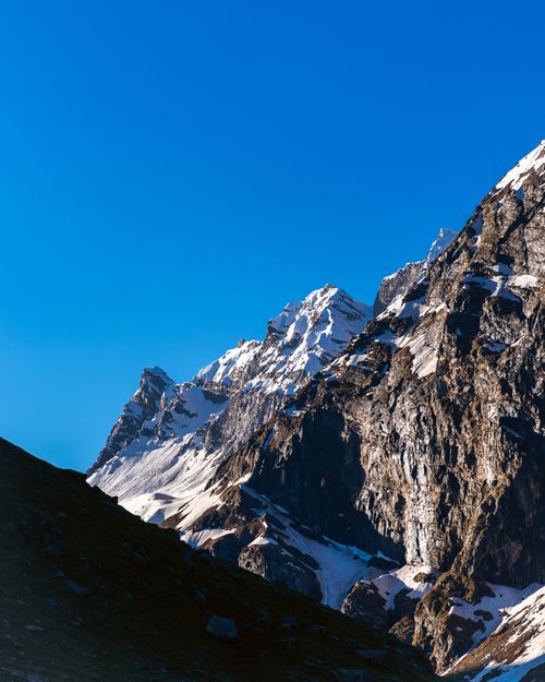 Free Vivid capture of the Himalayan mountain range under a clear blue sky, showcasing snow-covered peaks. Stock Photo