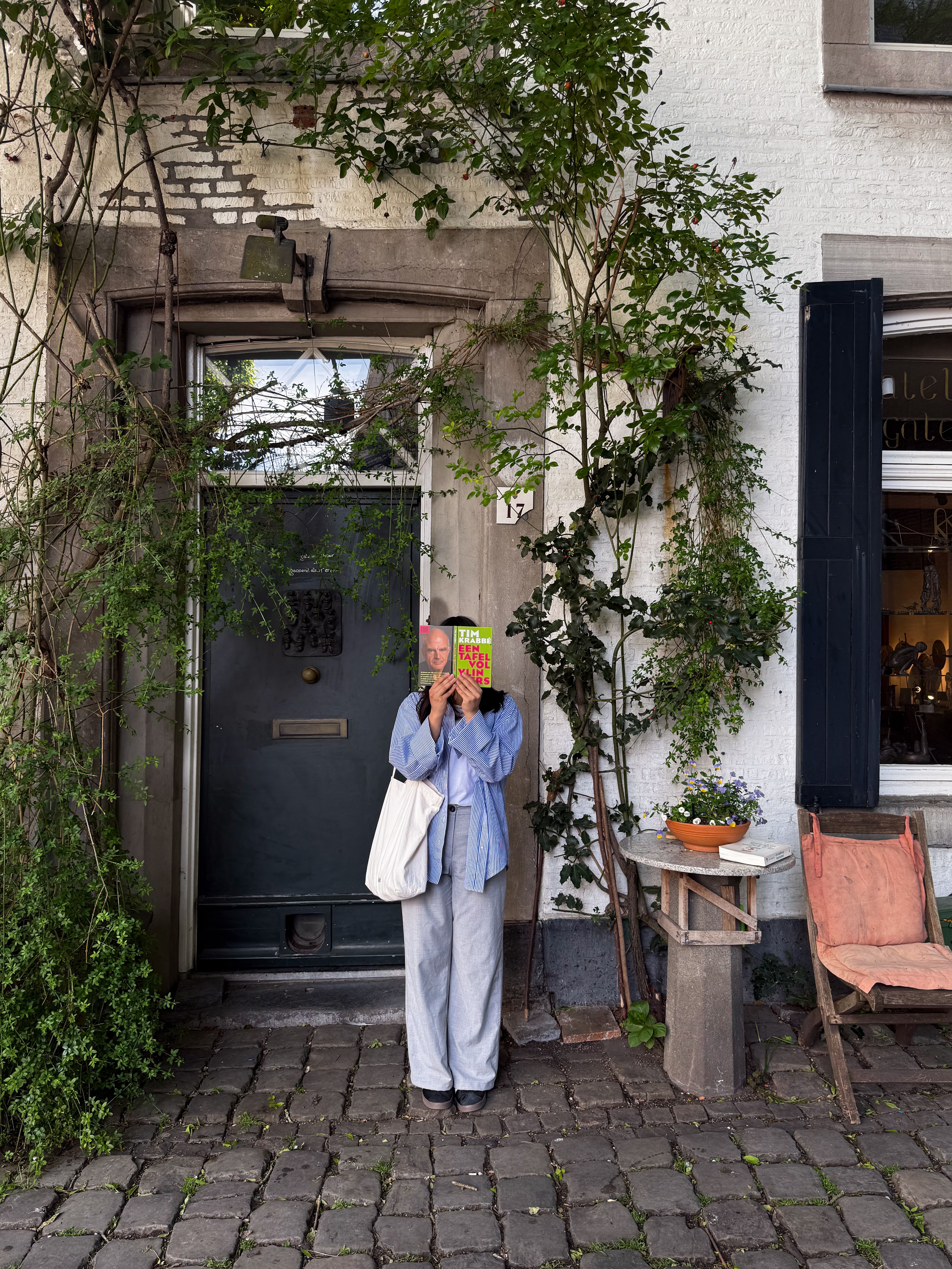 A person enjoys a quiet moment outside a charming home in Maastricht, Holland.