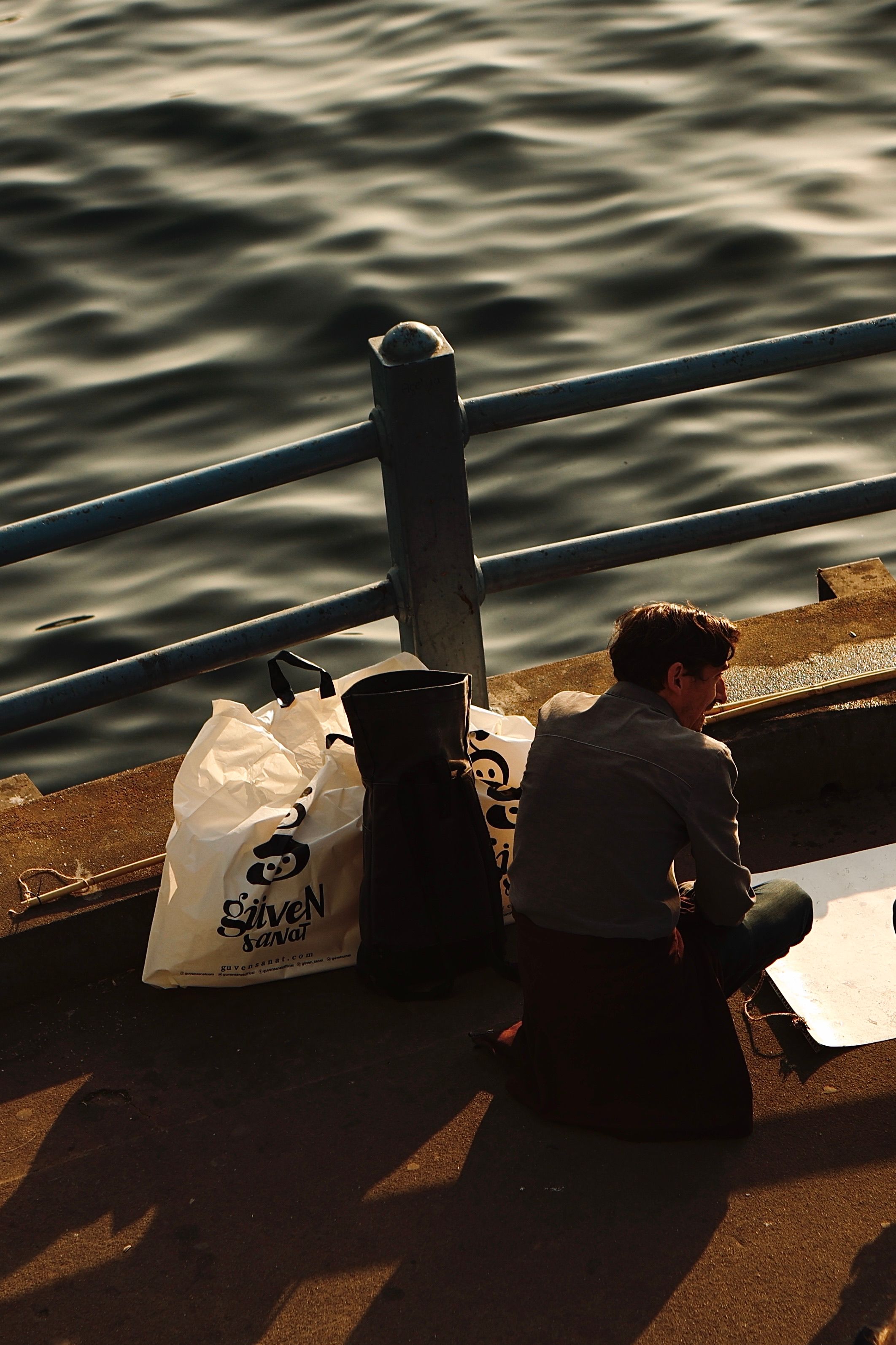 Contemplative Moment by the Waterside at Sunset · Free Stock Photo